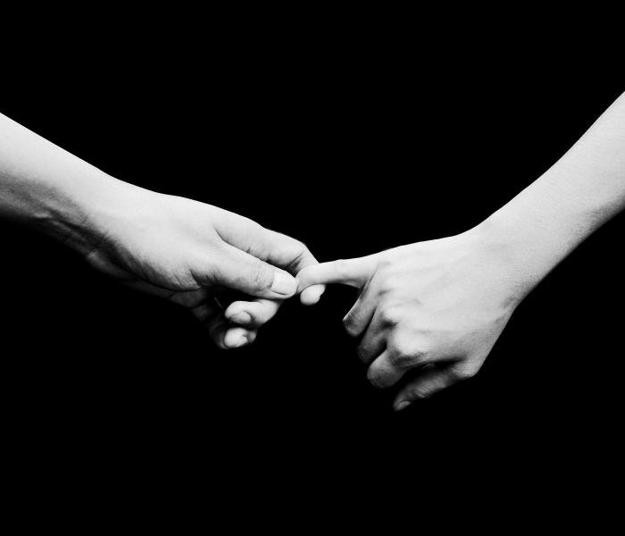 Two people holding hands