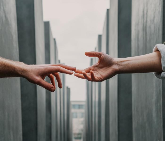 two hands reaching for each other