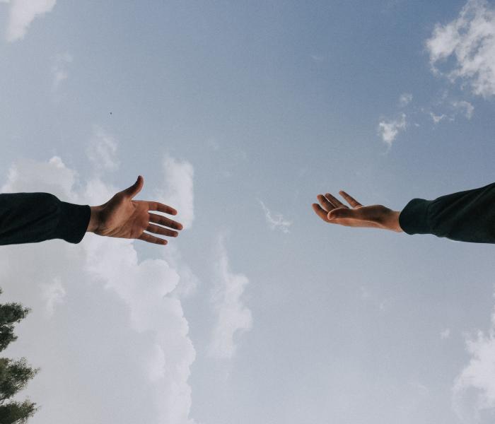 Hands reaching for each other