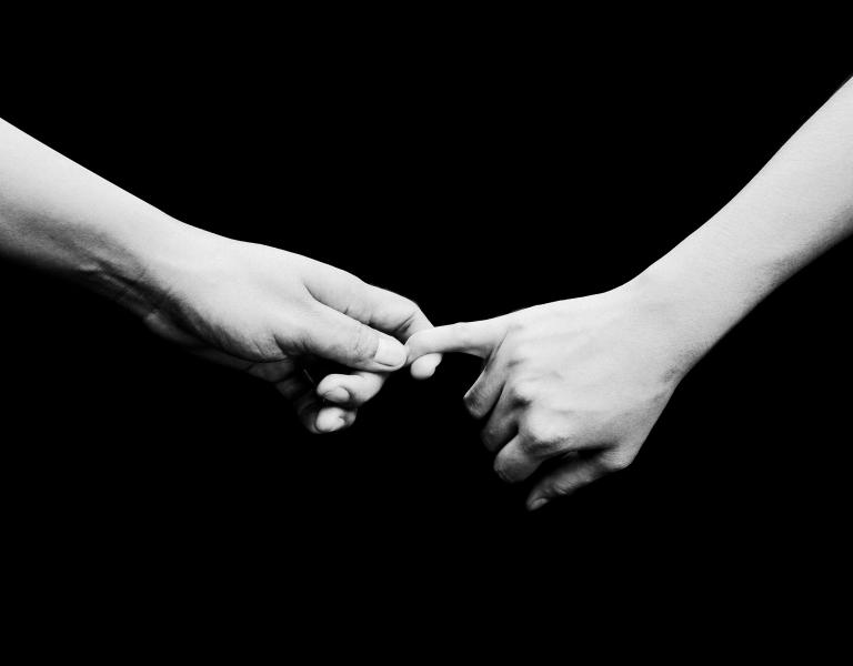 Two people holding hands