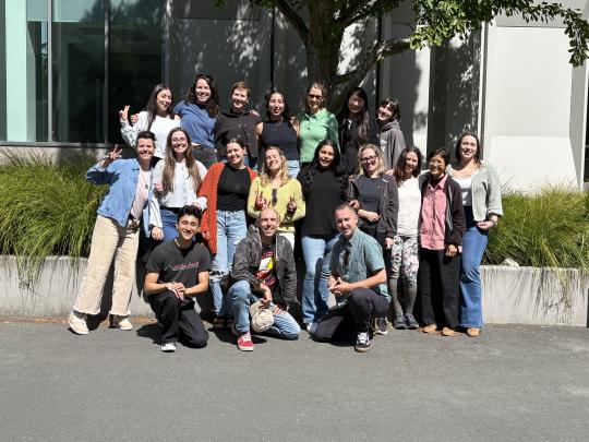 The Clinical Mental Health Counseling class of 2026 smile in the sun.