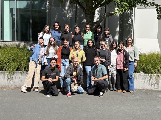 The Clinical Mental Health Counseling class of 2026 smile in the sun.