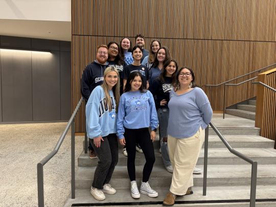 The School Counseling class of 2026 is all smiles as they pose along the stairwell!