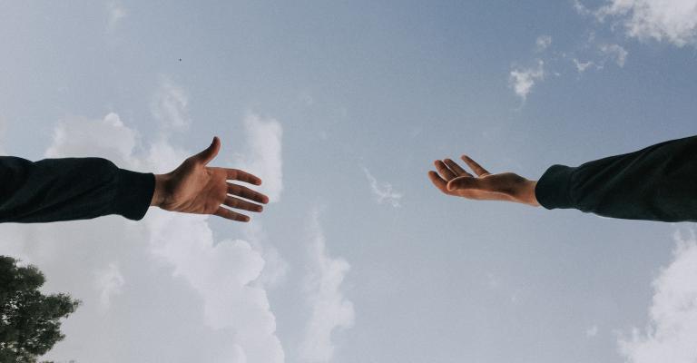 Hands reaching for each other